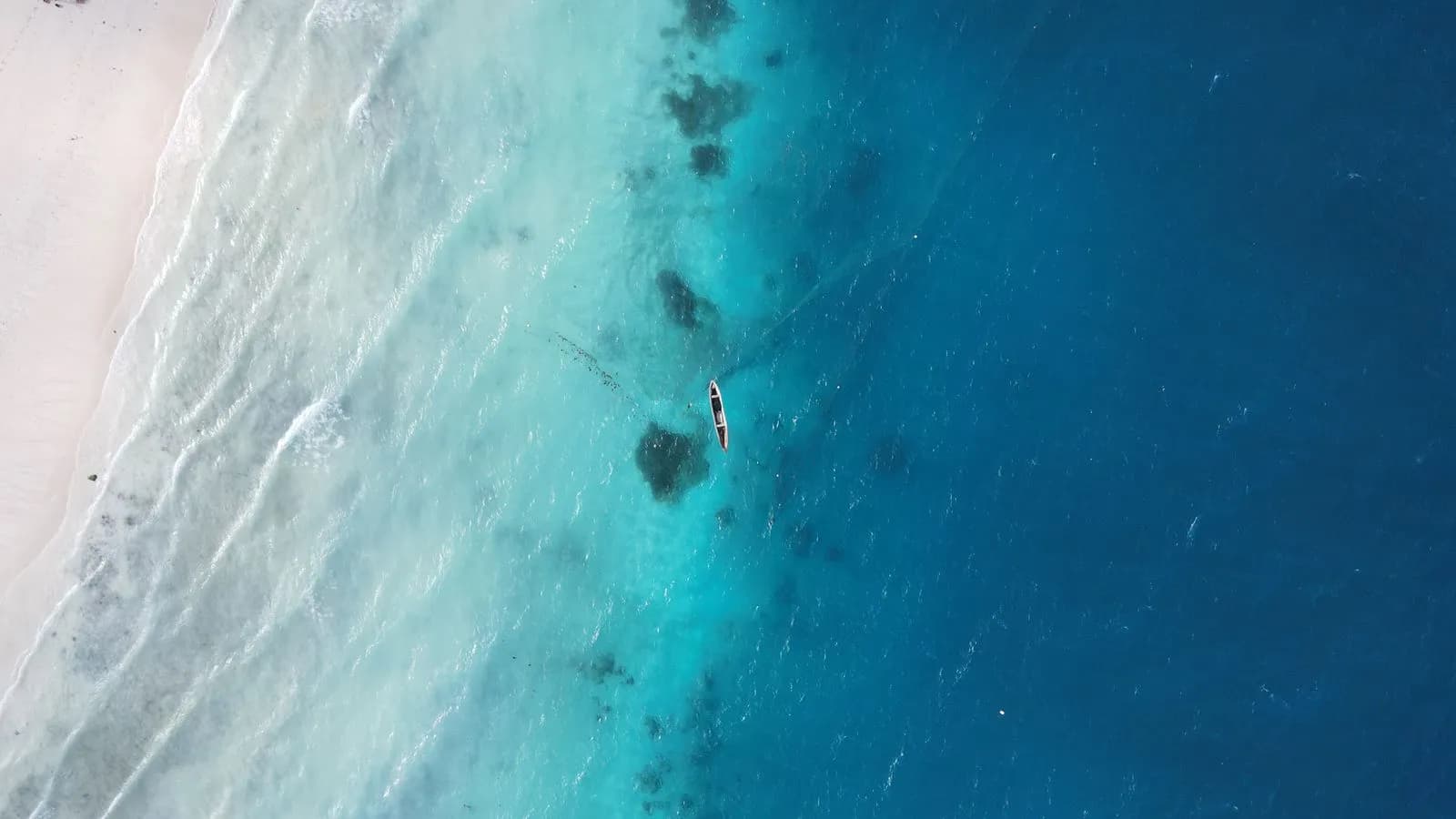 Aerial view of the white sand and reef edge at Matemwe on the north east coast of Zanzibar
