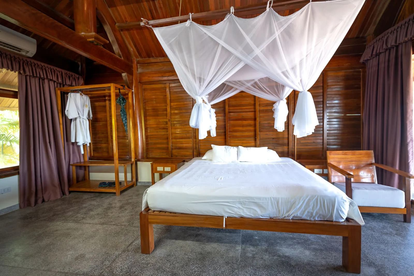 A mosquito net over a bed in a tropical room